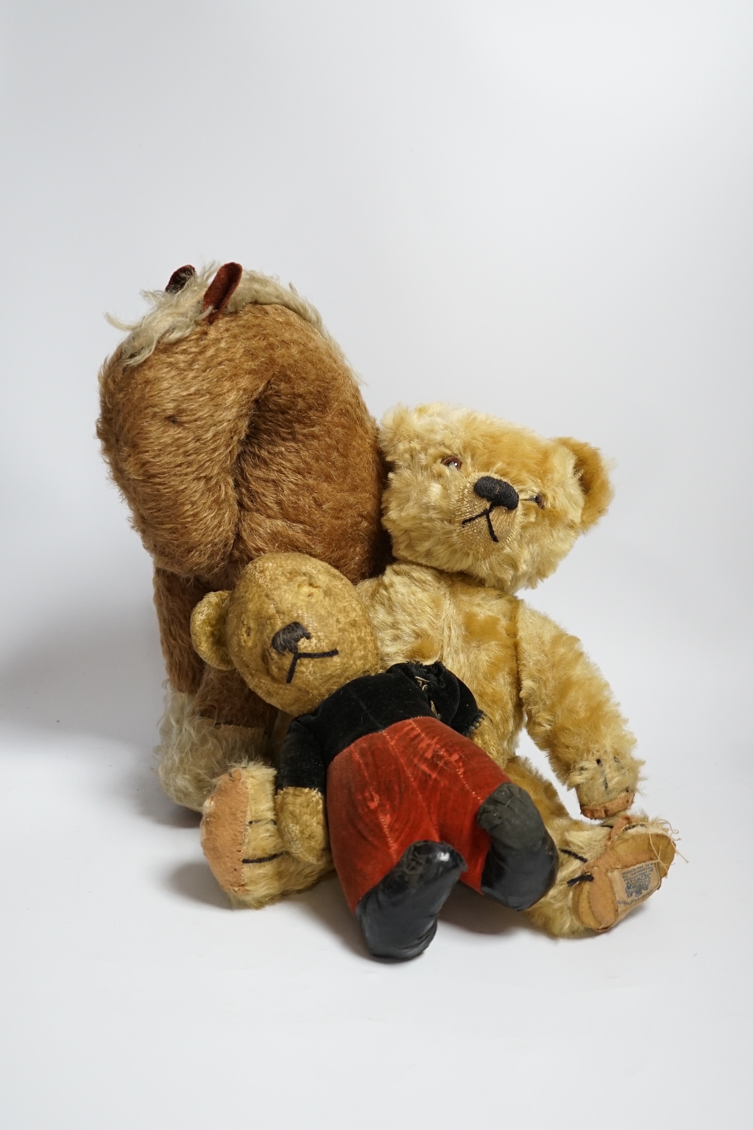 A Chad Valley teddy bear, 34cm high, a smaller bear in velvet clothes and a Merrythought horse